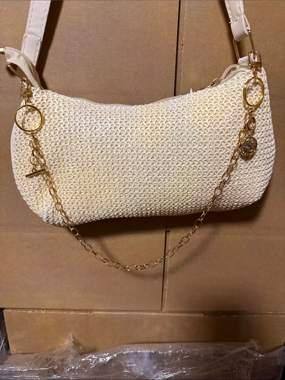 Woven Cream Shoulder Bag with Gold Chain Accent and a yellow jewel attached